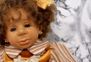 crying doll, to illustrate mourning over the loss of in-person church services